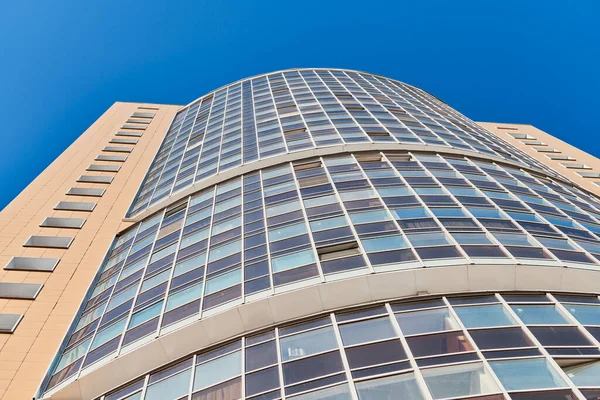 Multistorey building. Rhythm in photography. Multi-storey facade, windows and block of flats, close up. Modern apartments in high raised building. Angle perspective.