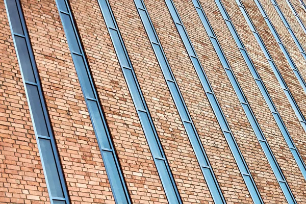 Multistorey building. Rhythm in photography. Multi-storey facade, windows and block of flats, close up. Modern apartments in high raised building. Angle perspective.