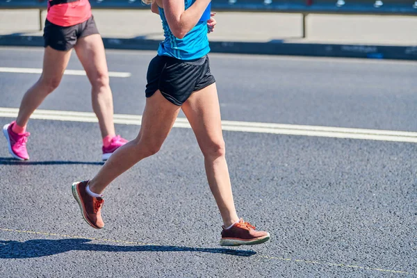 Running women. Sport women jogging in sportswear on city road. Healthy lifestyle, fitness hobby. Street marathon race, sprinting outdoor