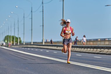 Voronezh, Rusya - 24.08.2019 - Genç kız yol boyunca koşar. Koşu maratonu ve şampiyonluk yarışması, fotokopi alanı. Sokak dışarı koşuyor. Sağlıklı spor etkinliği.