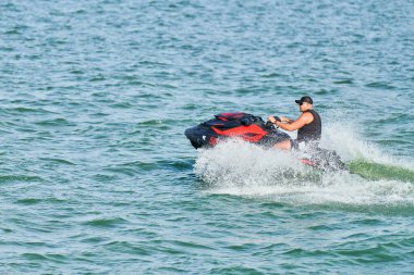 Voronezh, Rusya - 23.08.2019 - Su motosikletli adam. Yaz tatilinde tropikal denizlerdeki şahsi su araçlarında. Genç adam deniz yolculuğu hobisi. PWC spor etkinliği