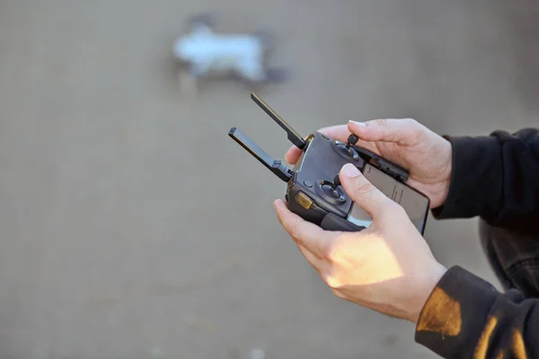 Drone remote Controller in operator hands. Drone preparation for takeoff. Quadcopter with camera for taking video and photos. Remote control air delivery and spy.