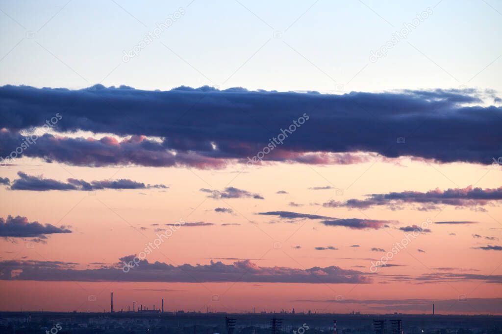 City sunset sky. Beautiful scenic evening time over city skyline. Colorful sundown. Clear calm weather at dusk