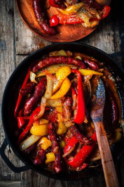 Demir panoda sosis, biber ve soğan. Seçici odak noktası.