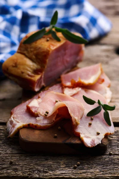 The cut  a smoked pork on a wooden table