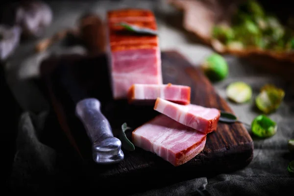 The cut  a Smoked bacon on a cutting board — Stock Photo, Image