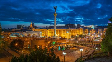 View of Maidan Nezalezhnosti against the background of the sunset sky with people walking near the fountains and Independence Monument of Ukraine, Kiev, Kyiv clipart