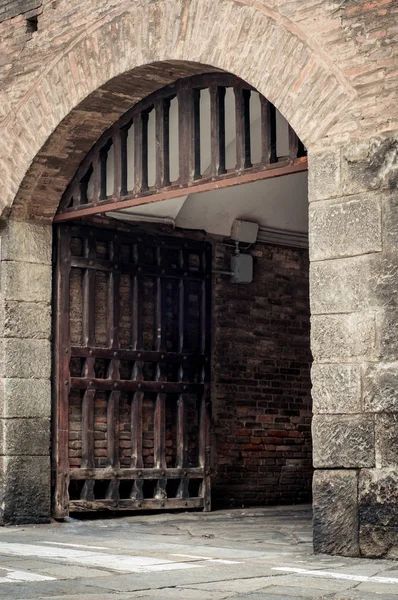 Large wooden door open in rock castle wall — Stock Photo, Image