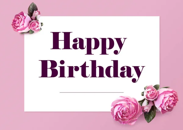 Elegant Happy Birthday Greeting Card. Text on white sheet of paper and isolated flowers of peonies on a pink background. Creative layout for a holiday, beautiful typography in frame.