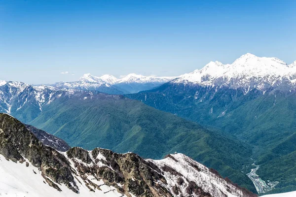 mountain valley with snow-capped mountain peaks