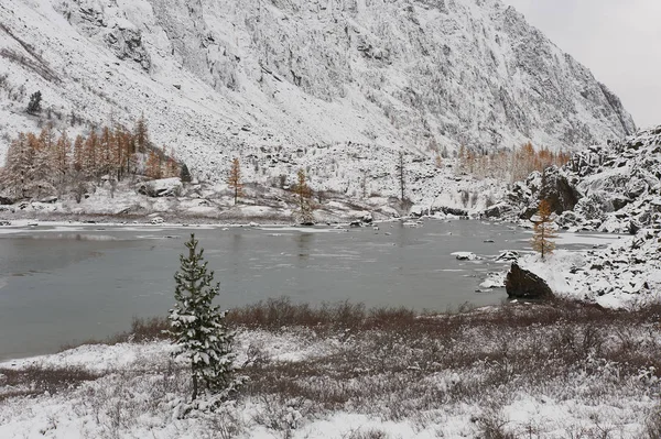 Cloudy morning. Snow-covered winter mountain lake, Russia, Siberia, Altai mountains, Chuya ridge.