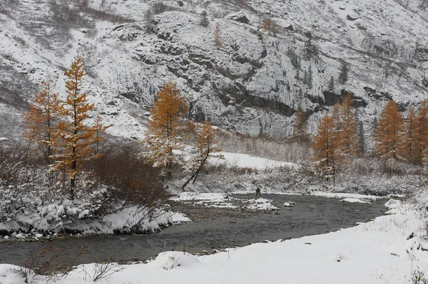 Cloudy morning. Snow-covered winter mountain lake, Russia, Siberia, Altai mountains, Chuya ridge.