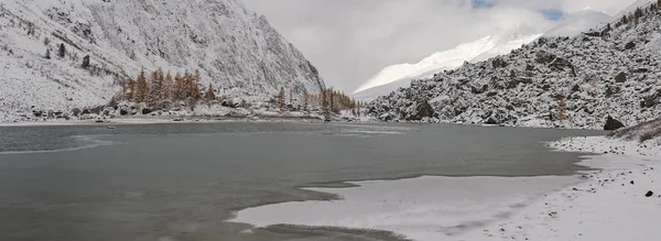 Cloudy morning. Snow-covered winter mountain lake, Russia, Siberia, Altai mountains, Chuya ridge.