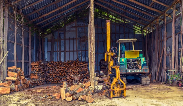 excavator in the wood shed