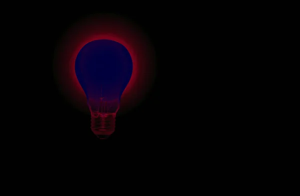 dark blue light bulb with red halo of light on a black background copy space,concept of idea,brainstorm or power and energy