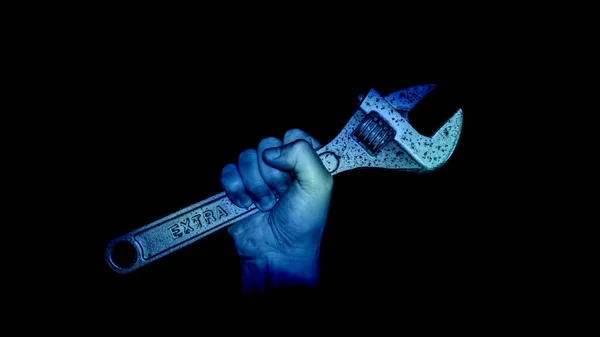 blue hand with wrench on black background