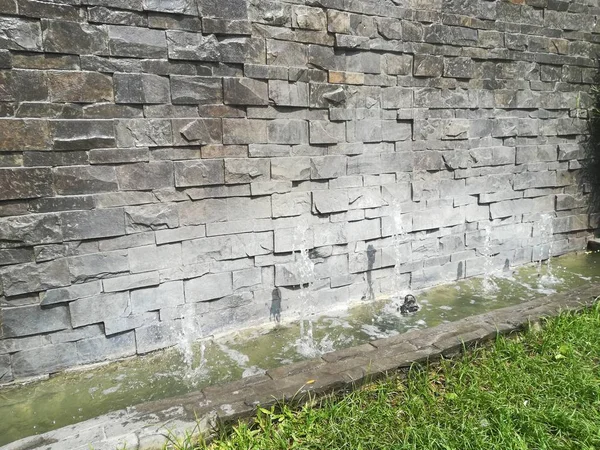 eski gri tuğla duvar küçük havuz ve Çeşme