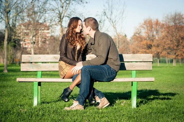 Happy Young Couple Sitting Outdoors Bench — Fotografia de Stock