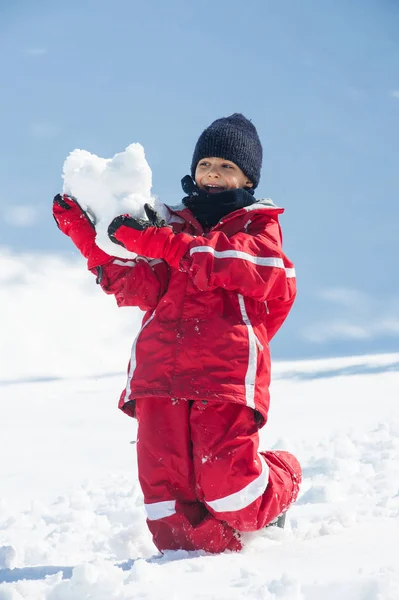 Νεαρό Παιδί Διασκεδάζει Στο Χιόνι Χιονόμπαλες — Φωτογραφία Αρχείου