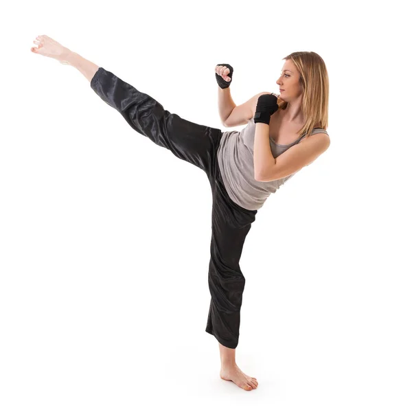 Blonde martial arts girl exercising taekondo. Studio isolated po — Stock Photo, Image
