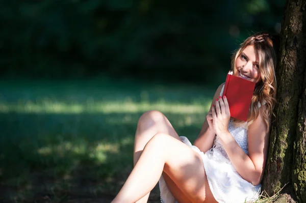 Bella Giovane Donna Sorridente Con Libro Sotto Albero Nel Parco — Foto Stock