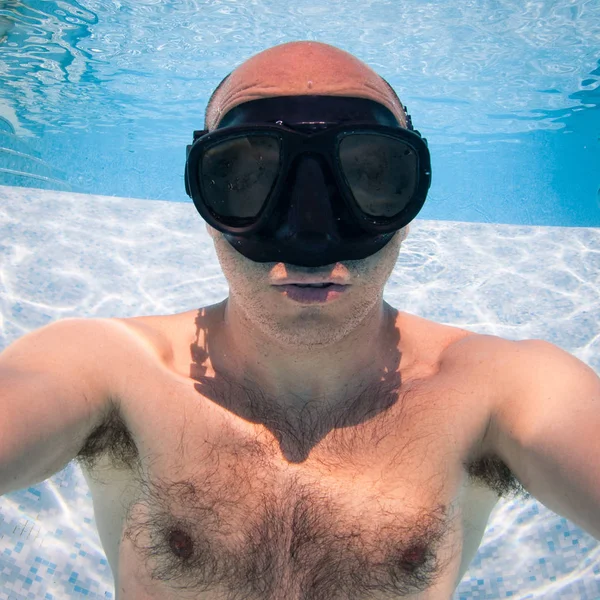Unterwasserporträt eines glatzköpfigen Mannes mit schwarzer Maske im Schwimmbad — Stockfoto