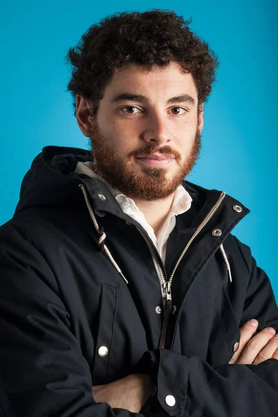 Close up portrait of confident young man wearing winter jacket a — Stock Photo, Image