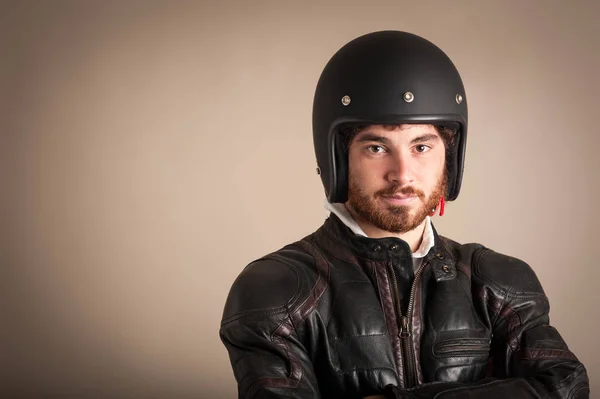 Portrait of confident young man wearing leather jacket and helme — Stock Photo, Image