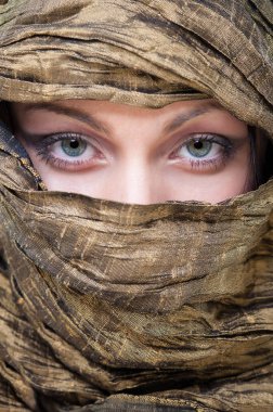 Close up portrait of veiled woman with beautiful blue eyes.