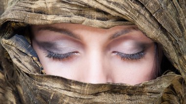 Portrait of veiled woman with closed eyes. 