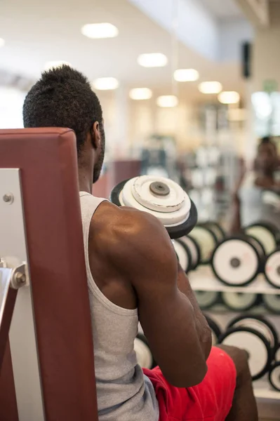 Joven negro africano hombre retrato ejercicio con dumbbells en th — Foto de Stock