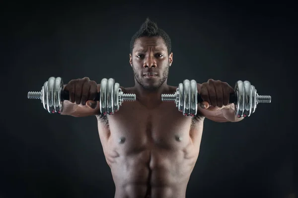 Confident young man shirtless portrait training with dumb-bell a — Stock Photo, Image