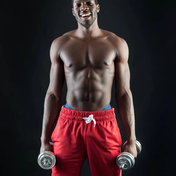 Happy young man shirtless portrait training with dumb-bell again — Stock Photo, Image