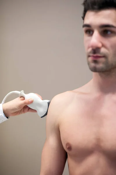 Female doctor visiting her male patient with ultrasound in medic — Stock Photo, Image