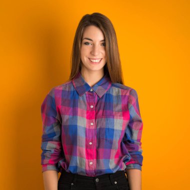 beautiful young woman in a dress on a color background