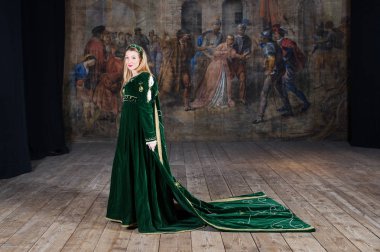 Young woman dressed with classical costume portrait inside old theater of Ripatransone, Italy. 