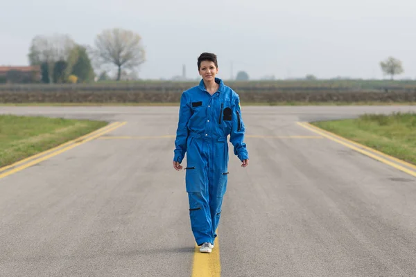 年轻女性飞行员在跑道上行走的肖像 — 图库照片