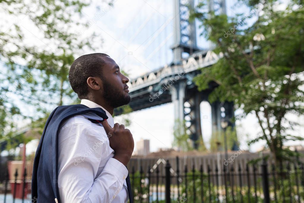 Young confident businessman portrait walking in Brooklyn Dumbo P