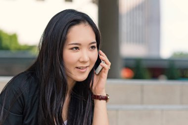 Young businesswoman portrait talking at the phone.