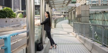 Panoramic image of young businesswoman in Hong Kong. 