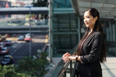 Young businesswoman portrait in Hong Kong in a sunny day.