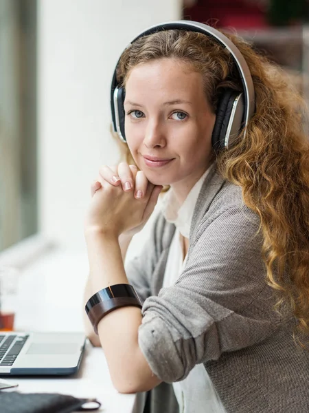 Zakenvrouw portret tijdens het werken met haar laptop en listeni — Stockfoto