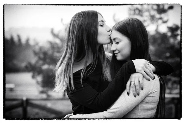 Portrait Young Sisters Hugging Outdoors Park Digital Manipulation Simulate Black — Stock Photo, Image