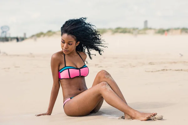 Sensual young woman full body portrait wearing bikini relaxing o