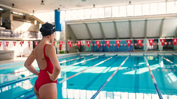 Woman professional swimmer wearing red swimsuit inside swimming — 스톡 사진