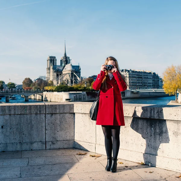 Young blonde woman full body portrait taking photo with camera w