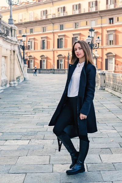 Beautiful blond woman full body portrait outdoors. Pincio staircase, Bologna, Italy.