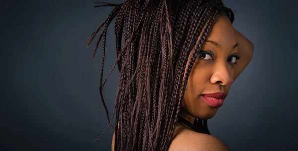 Beautiful African young woman close up portrait with braids agai — Stock Photo, Image