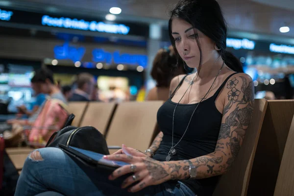 Joven morena tatuada mujer retrato trabajando con la tableta en th — Foto de Stock