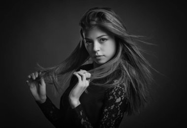 Siyah ceket giyen uzun saçlı Intimate güzel kadın stüdyo portre. Siyah beyaz görüntü.